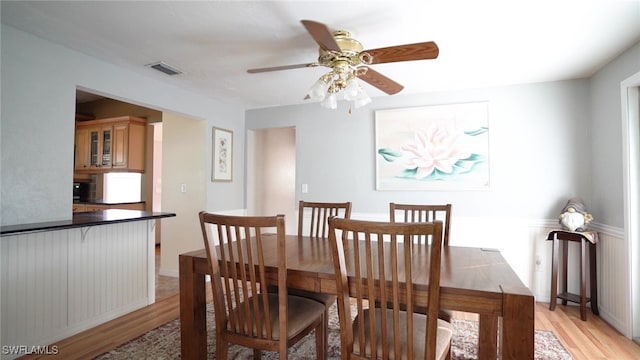 dining room featuring visible vents, a ceiling fan, and light wood finished floors