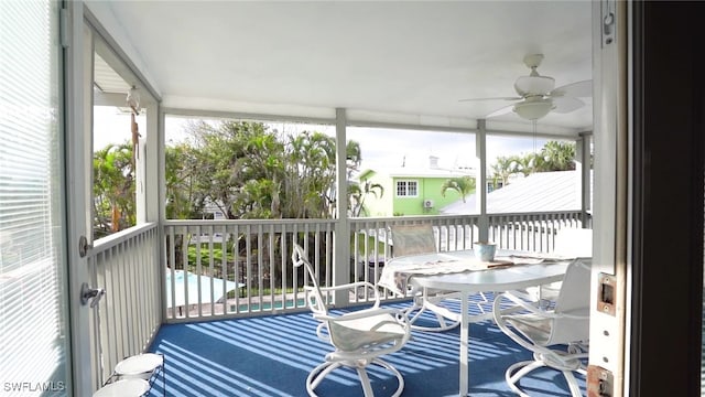 sunroom featuring a ceiling fan