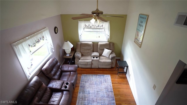 living room with plenty of natural light, light hardwood / wood-style floors, and ceiling fan