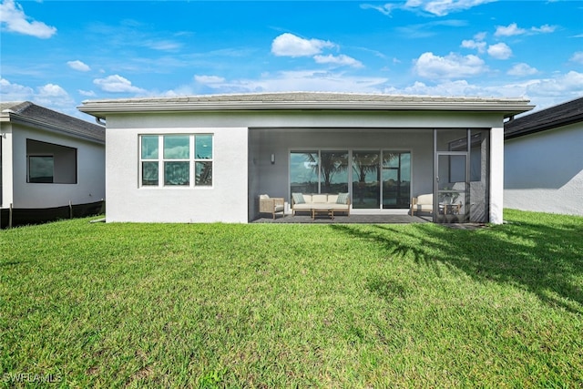 12390 Purple Ficus Way, Naples, FL 34120 - rear view of house featuring a lawn, stucco siding, outdoor lounge area, and a sunroom