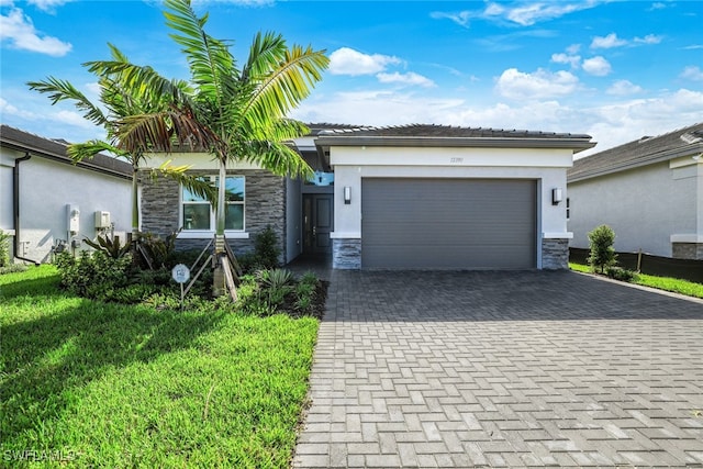 12390 Purple Ficus Way, Naples, FL 34120 - ranch-style home with stone siding, stucco siding, decorative driveway, and a garage