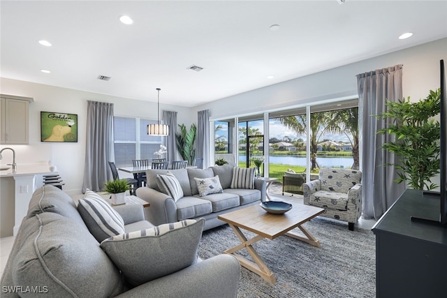 12390 Purple Ficus Way, Naples, FL 34120 - living room featuring recessed lighting and a water view