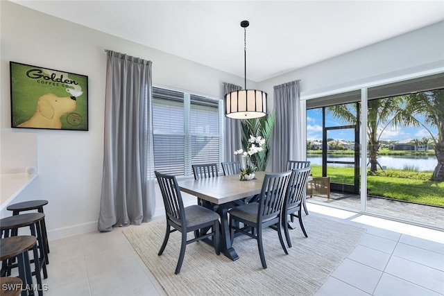 tiled dining space featuring a water view