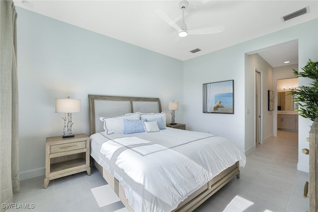 tiled bedroom with ceiling fan and connected bathroom