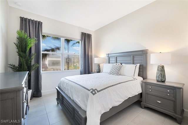 12390 Purple Ficus Way, Naples, FL 34120 - bedroom with light tile patterned floors and baseboards