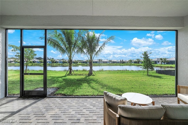 unfurnished sunroom with a water view