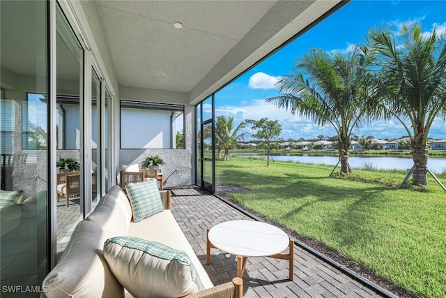 sunroom / solarium with a water view