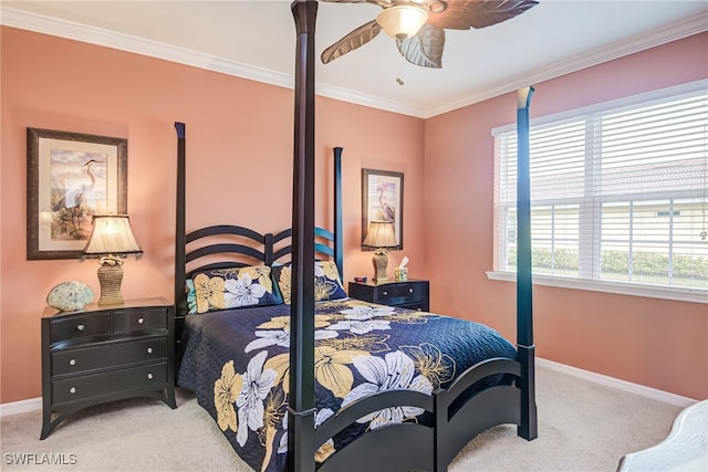 carpeted bedroom with ceiling fan and ornamental molding