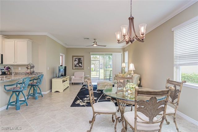 tiled dining room with ornamental molding, ceiling fan with notable chandelier, and sink