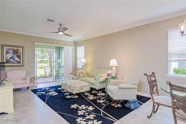 tiled living room with ceiling fan, plenty of natural light, and ornamental molding