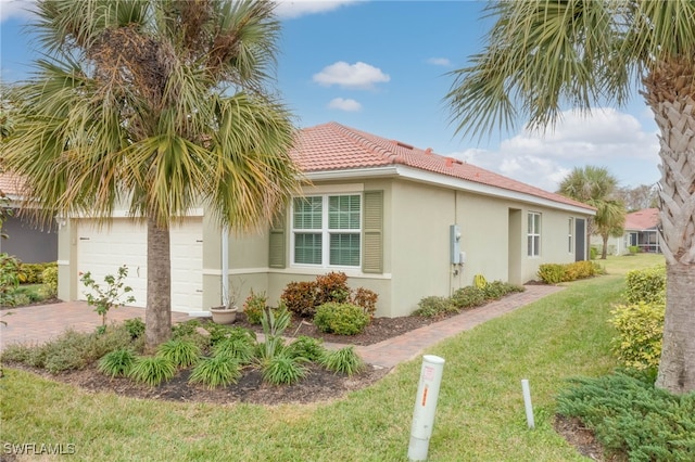 view of property exterior featuring a garage and a lawn