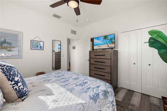 bedroom with dark wood-type flooring, a closet, and ceiling fan