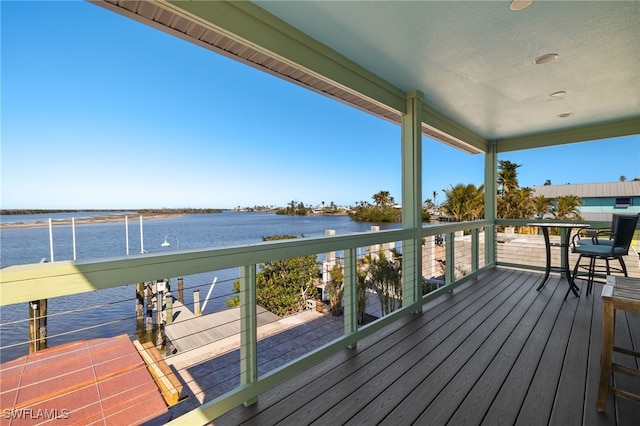 wooden deck featuring a water view