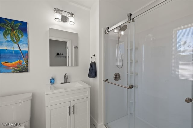 bathroom featuring vanity, toilet, and walk in shower