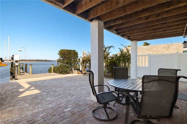 view of patio / terrace with a boat dock and a water view