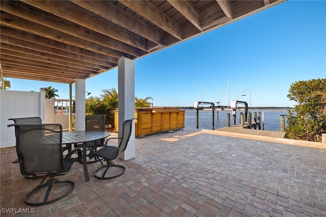 view of patio / terrace featuring a boat dock and a water view