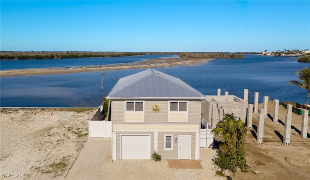 view of front of house with a water view and a garage