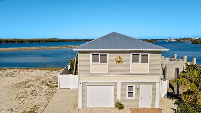 view of front facade featuring a garage and a water view