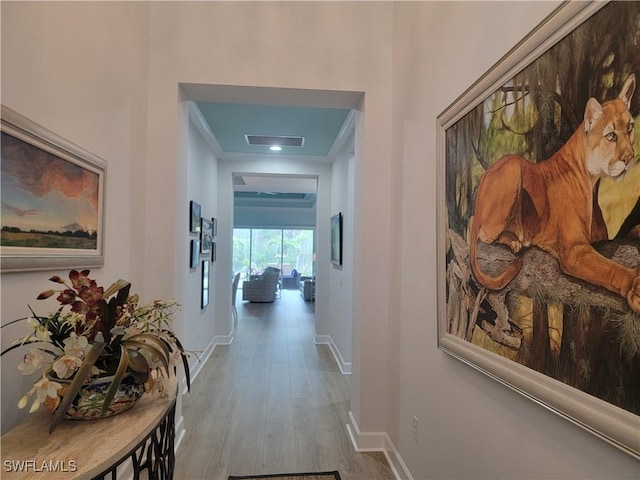 hall with hardwood / wood-style floors and ornamental molding