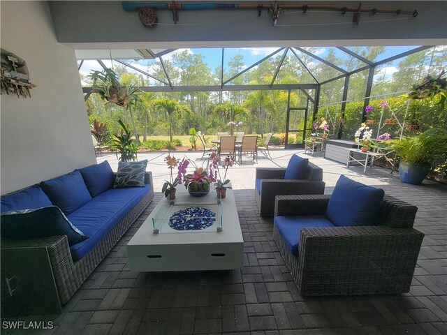 view of patio featuring an outdoor living space with a fire pit and glass enclosure