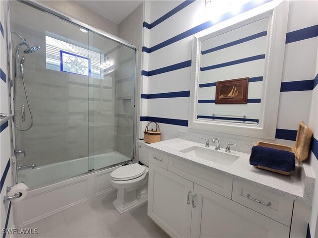 full bathroom with vanity, combined bath / shower with glass door, and toilet