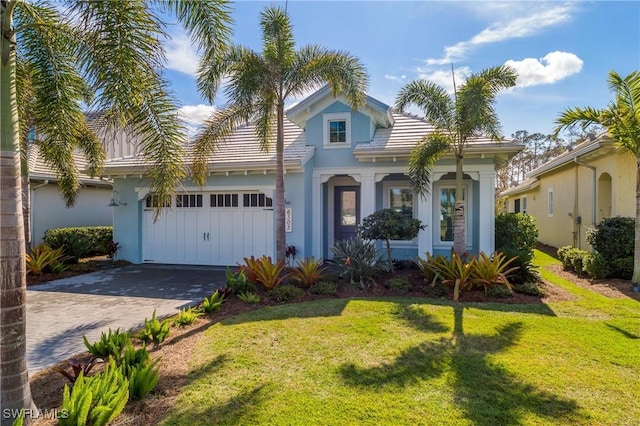 view of front of property featuring a garage and a front yard