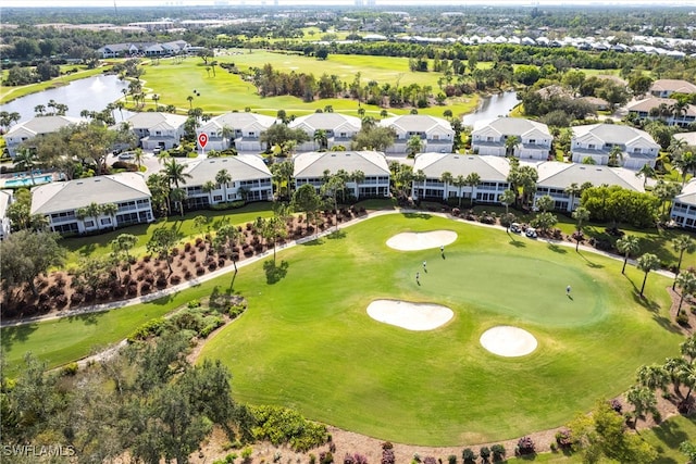 drone / aerial view featuring a residential view, a water view, and view of golf course