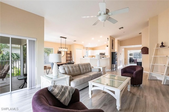 living area with light wood finished floors, visible vents, ceiling fan, vaulted ceiling, and recessed lighting