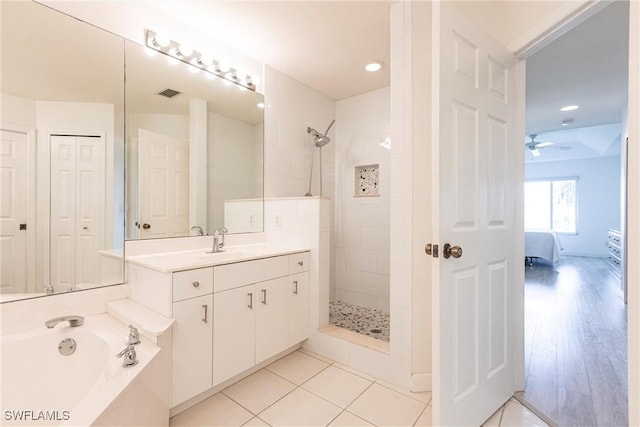 ensuite bathroom with vanity, a bath, a ceiling fan, and tiled shower