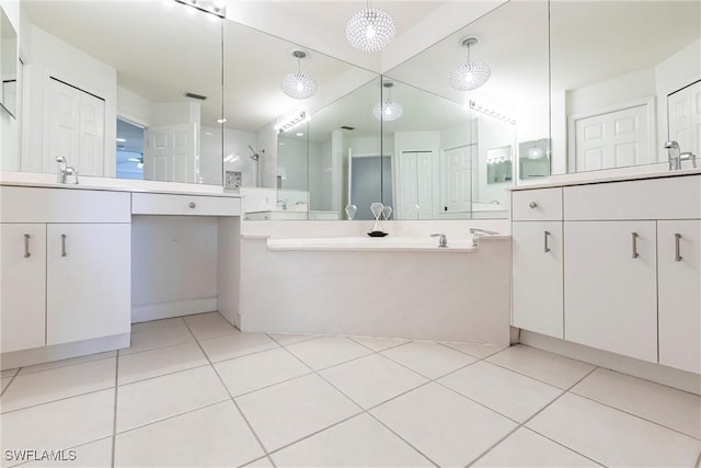 full bath featuring walk in shower, tile patterned floors, two vanities, and a sink