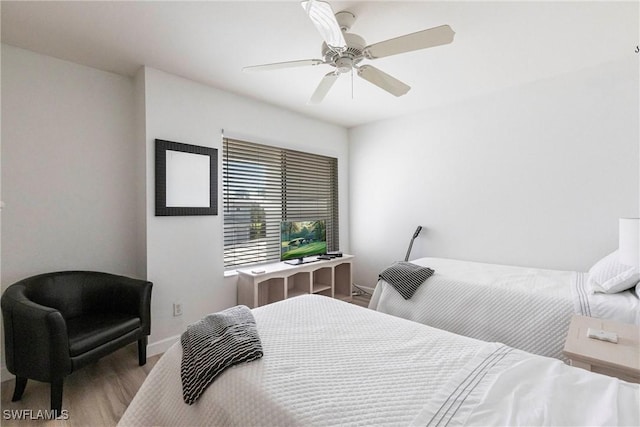 bedroom featuring a ceiling fan, wood finished floors, and baseboards