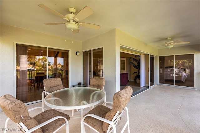 sunroom featuring ceiling fan