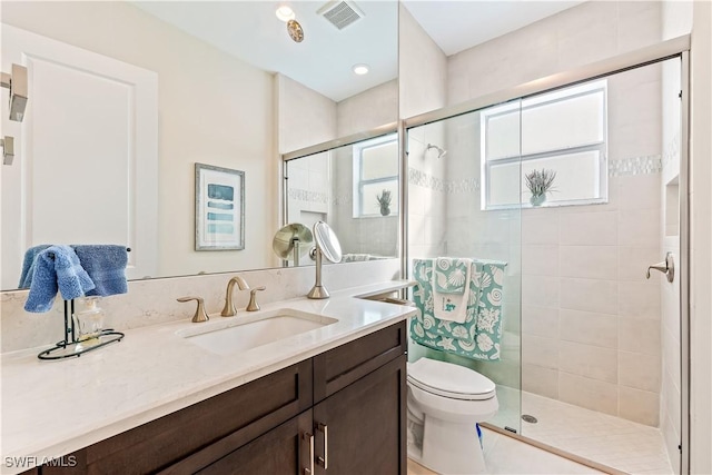 bathroom with vanity, toilet, and walk in shower