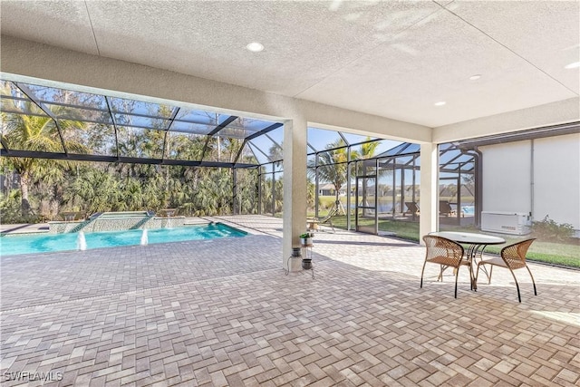 view of pool with a patio, a lanai, and a pool with connected hot tub