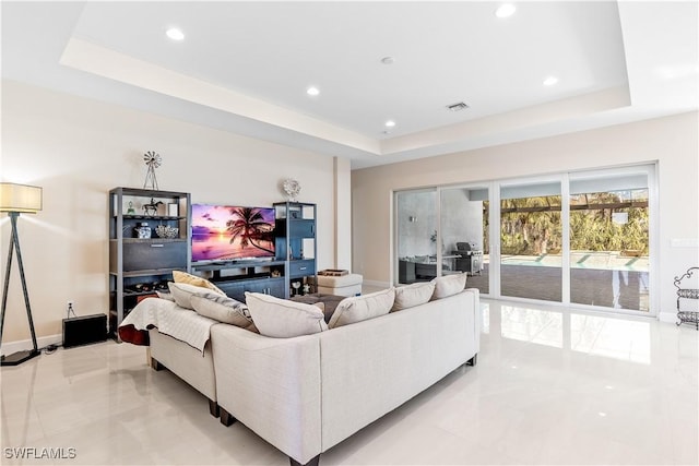 living room featuring a raised ceiling