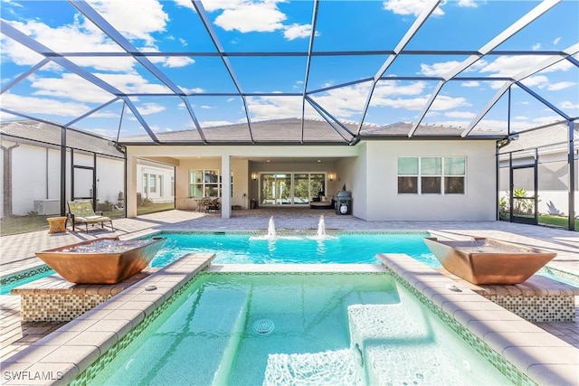 rear view of property with a lanai, a patio area, and pool water feature