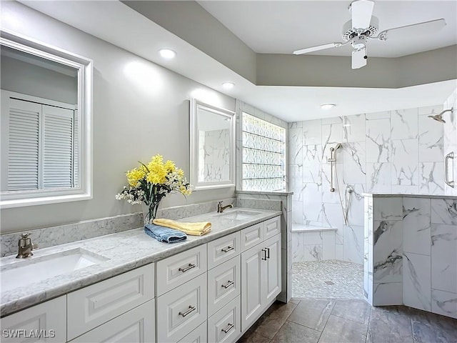 bathroom featuring recessed lighting, a sink, a marble finish shower, and a ceiling fan