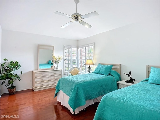 bedroom with wood finished floors and a ceiling fan