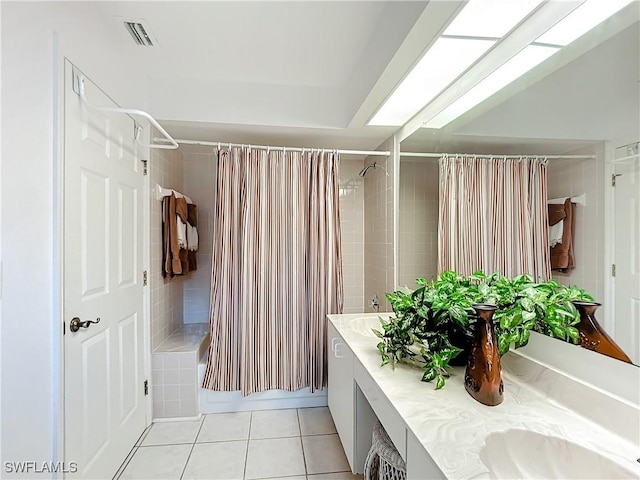 full bath featuring double vanity, visible vents, shower / tub combo with curtain, tile patterned floors, and a sink