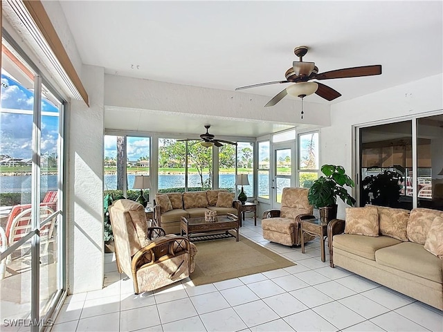 sunroom featuring a water view and ceiling fan