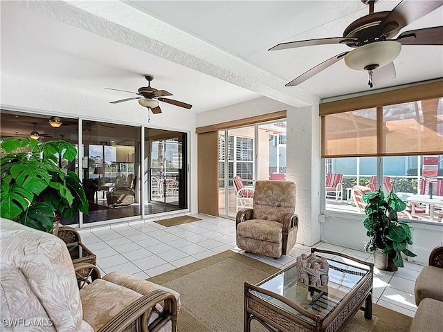 sunroom / solarium featuring ceiling fan