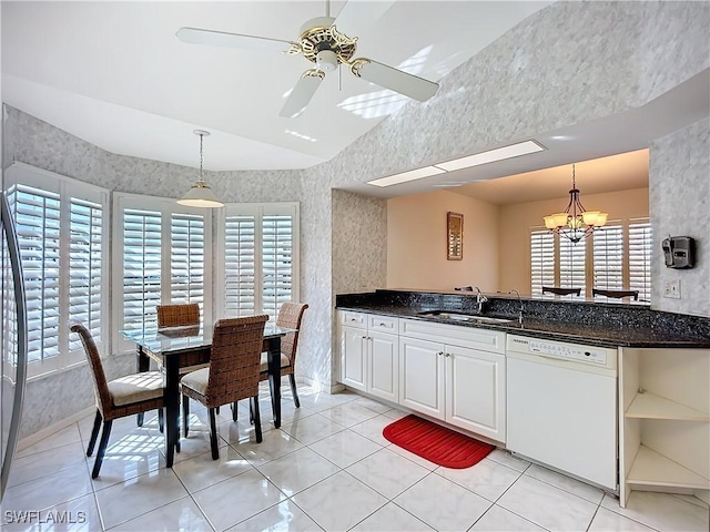 kitchen with pendant lighting, open shelves, vaulted ceiling, a sink, and dishwasher