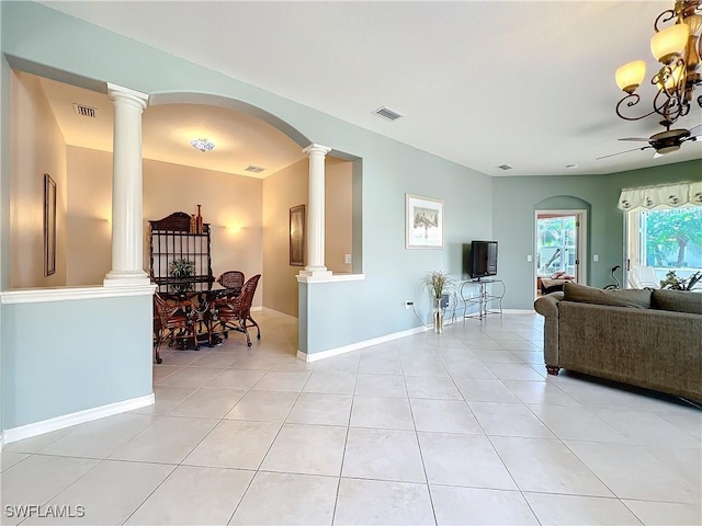 living room featuring light tile patterned flooring and decorative columns