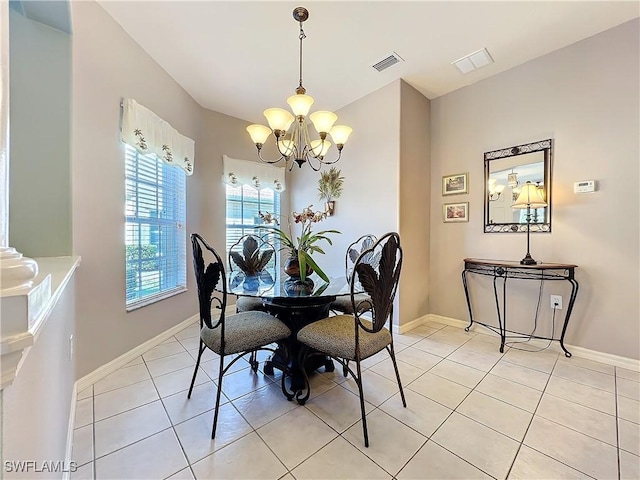 dining space with light tile patterned flooring and a notable chandelier