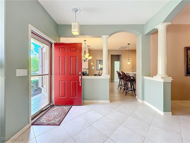 tiled foyer entrance featuring ornate columns