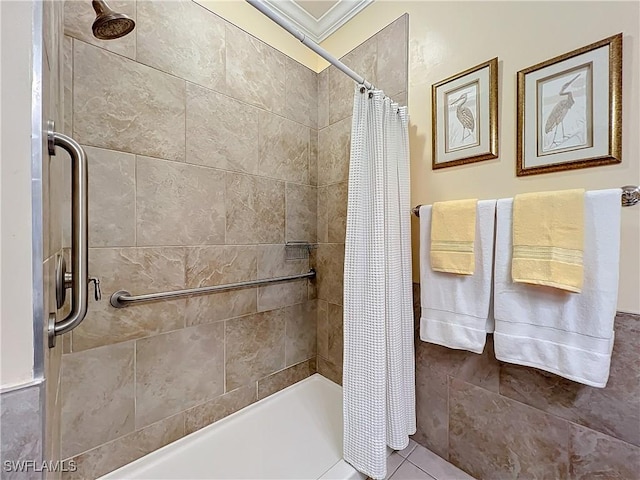 bathroom with a shower with shower curtain, ornamental molding, and tile patterned floors