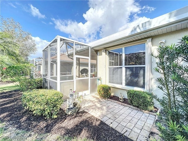 view of side of property featuring a lanai