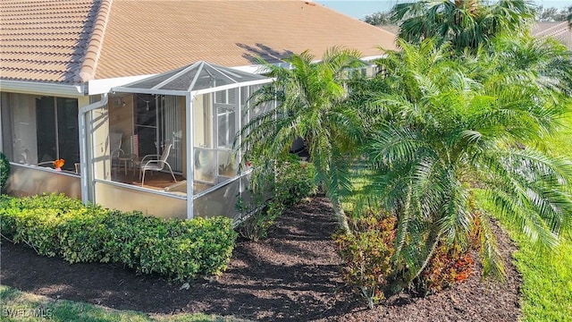 view of side of home featuring a lanai