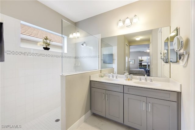 bathroom featuring vanity, ceiling fan, and tiled shower