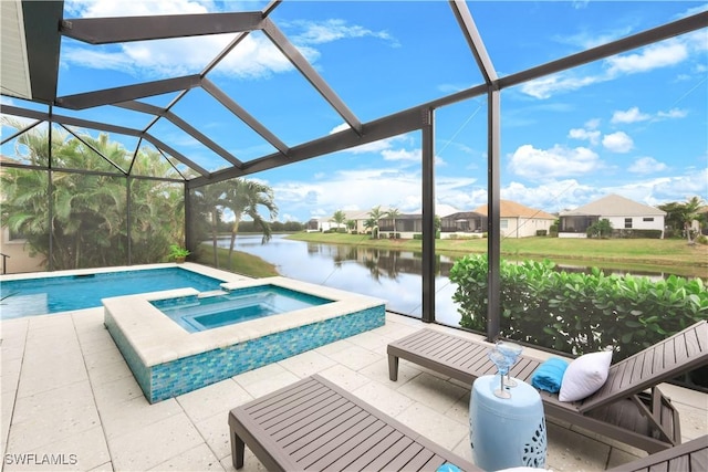 view of swimming pool featuring a water view, a patio area, a lanai, and an in ground hot tub